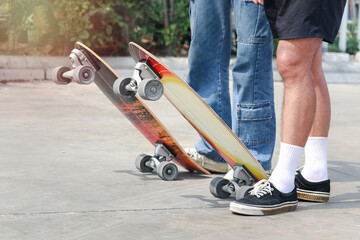 Close-up of surf skate board with young people enjoy having fun with skateboard extreme sport...