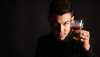 Sommelier tastes expensive drink. businessman in elegant suit drink brandy. sexy barkeeper with luxury beverage. mens club. time to relax. bad habit. man holding brandy in hand. copy space