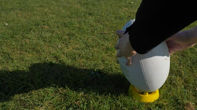 Close Up Shot Of Rugby Ball Being Placed On Tee