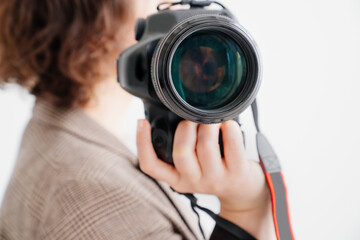 Naklejka premium professional SLR camera in women's hands. fascination with photography