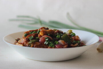 Air fried cottage cheese cubes and baby corn prepared with chilli sauce. It is an Indo Chinese dish, locally known as chilly paneer with baby corn