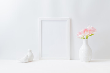 Mockup with a white frame and pink tulips in a vase on a light background
