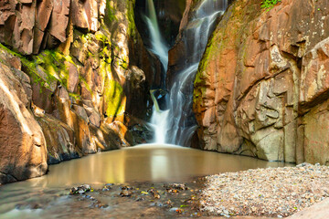 Fototapeta na wymiar Waterfall in the middle of rocks