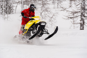 Mountain snowmobile riders ride on the slopes - obrazy, fototapety, plakaty
