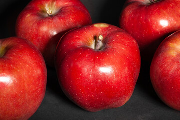 red delicious apple on black background