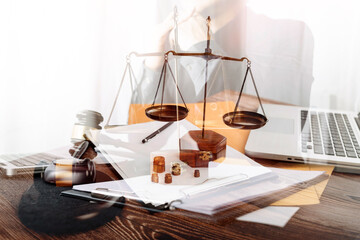 Business and lawyers discussing contract papers with brass scale on desk in office. Law, legal services, advice, justice and law concept picture with film grain effect