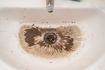 water drains into dirty sink drain after blockage is removed. plumbing tool for mechanical cleaning...