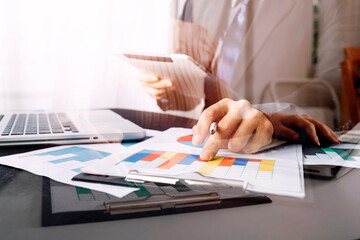 businessman holding coins putting in glass and using calculator. concept saving money and finance accounting.