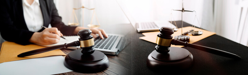 Close up of hand lawyer working signing contract paper with wooden gavel judge in the office. lawyer and law ,judiciary and legislature courtroom legal concept.