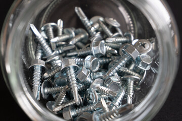 glass jar with screws inside. Concept organize material