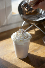 Chocolate milkshake sprinkled with cocoa