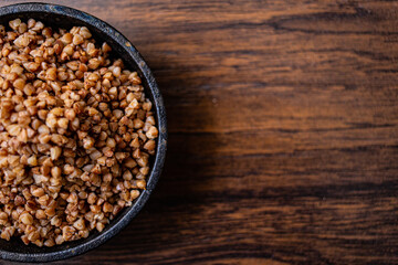 Buckwheat in a pan on wooden boards