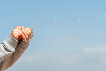 female hands squirting water from a syringe
