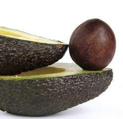 Avocado nucleus on cut avocados isolated on a white background