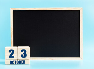Octotber 23. Day 23 of month, Cube calendar with date, empty frame on light blue background. Place for your text. Autumn month, day of the year concept