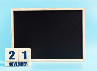 November 21. Day 21 of month, Cube calendar with date, empty frame on light blue background. Place for your text. Autumn month, day of the year concept