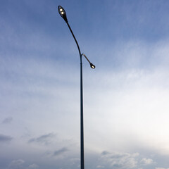 LED lighting of street lamps against the blue sky.