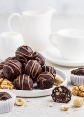 Delicious homemade dark chocolate sweets with hazelnuts and walnuts. Healthy candies. Chocolate truffles. Сandied roasted nuts. Selective focus