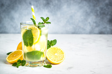 Lemonad in the glass at white table.