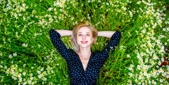 Above View At Blonde Woman In Black Dress Lying In Countryside Chamomiles Flowers Meadow