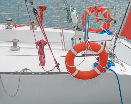 Closeup of yacht or passenger shipboard with lifebuoy rings and ropes