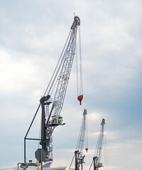 Fototapeta premium Group of construction lifting cranes at sky background