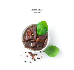 Natural, organic appetizer: dried, beef meat with spices and fresh basil.