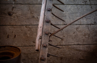 Old  vintage rake against wooden wall