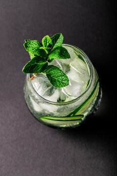 Glass Of Water With Cucumber And Mint On A Black Background