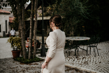 woman in beige elegant dress in nature 