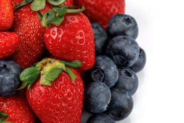 Strawberries with blueberries isolated on a white background. Close up.