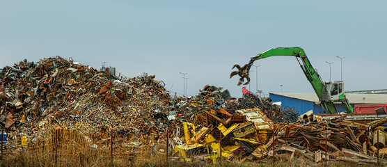 Grab crane works in waste recycling station