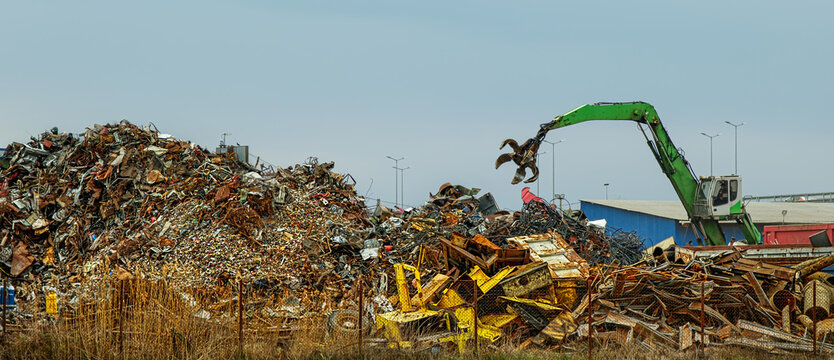 Grab crane works in waste recycling station - Powered by Adobe