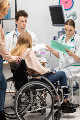 Obraz premium A wheelchair-bound teenager and her mother wait in a doctor's office. A nurse reviews the teen's test results