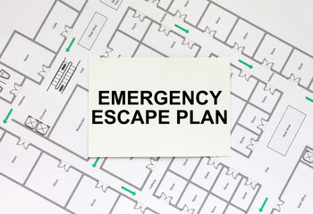 Business card with text Emergency Escape Plan on a construction drawing
