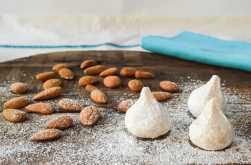 Fototapeta na wymiar Traditional Greek almond cookies amygdalota, with powdered sugar and almonds 