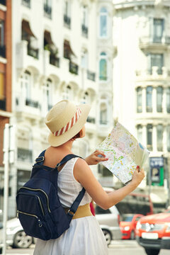woman tourist looking map on a street of european city, travel to Valencia.