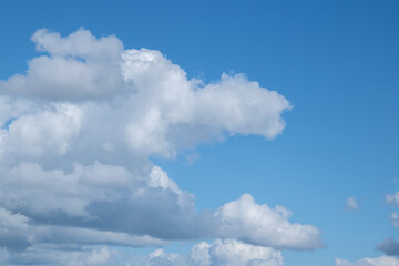 Naklejka na ściany i meble White and gray clouds in the blue sky.