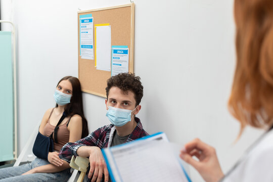 The doctor reads out the next person in line. During a pandemic, everyone must wear protective masks. Close-up shot