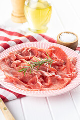 Sliced carpaccio. Raw beef meat.
