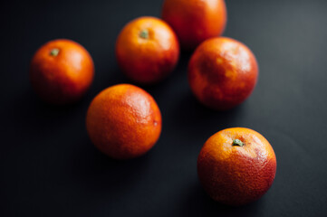 sicilian orange cut into pieces.
citrus, vitamins, on a dark background. wooden board. Healthy Eating.
food for rest. vegetarianism