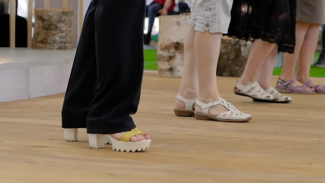 Close up of elderly women legs dancing and stomping at fitness event, exhibition - slow motion. Wellness, praticing, sport, feet dance, training, active old age concept