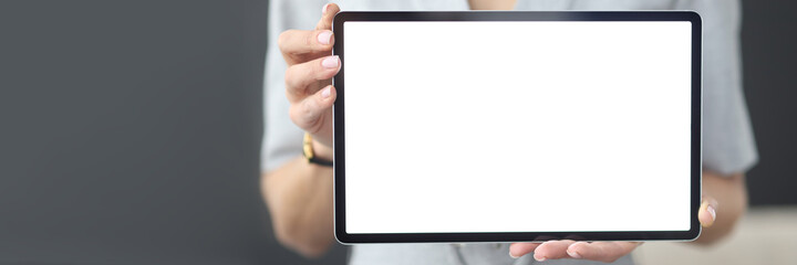 Obraz premium Female hands hold tablet with white screen