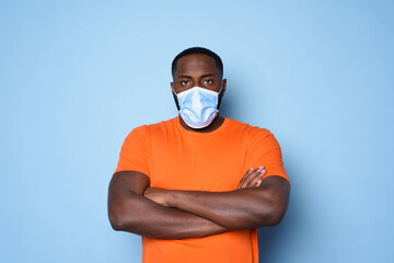 Man with face mask has a lot of questions and doubts about covid 19. cyan background