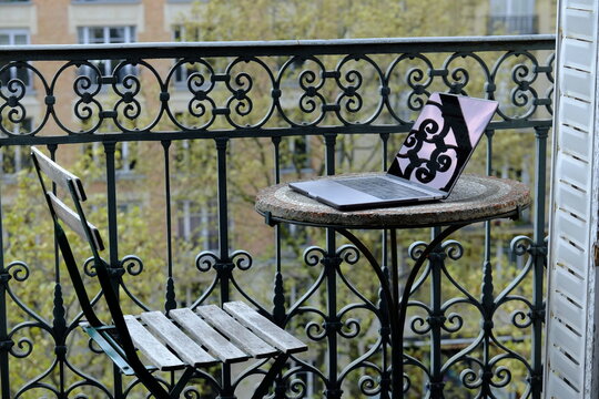 Working on a balcony with a parisian background. Paris, France.