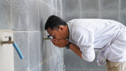 A portrait of an asian muslim ablution at mosque before pray