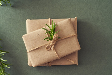Christmas presents wrapped in ecological recycled paper on green paper background