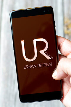 04-13-2021 Portsmouth, Hampshire, UK A Mobile Phone Or Cell Phone Being Held In A Hand Showing The Urban Retreat App On Screen