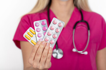 female nurse holding different pills. healthcare and medical concept.
