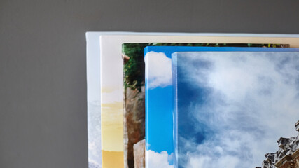 Canvas prints stacked on grey wall background. Photo printed on canvas